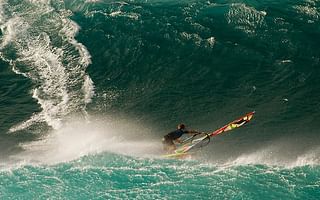 How can I overcome my fear of large waves while surfing?