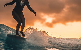 How do surfers stay on their board?